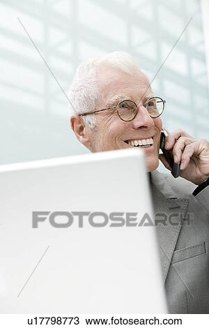 Older man using cell phone View Large Photo Image Stock Image - Older man using cell phone. Fotosearch