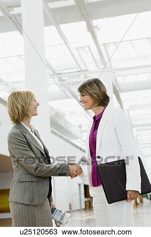Two women shaking hands View Large Photo Image Stock Image - Two women shaking hands. Fotosearch