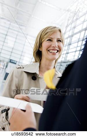 Stock Image - Woman checking in. Fotosearch