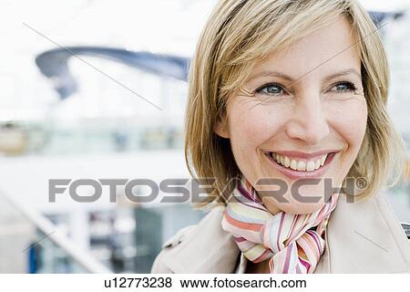 Woman close up smiling into distance View Large Photo Image Stock Photo - Woman close up smiling into distance. Fotosearch