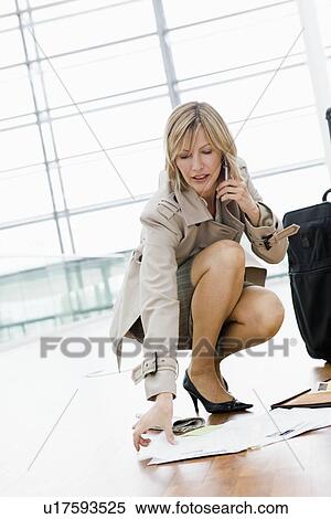 Woman collecting papers from the floor View Large Photo Image Stock Photography - Woman collecting papers from the floor. Fotosearch
