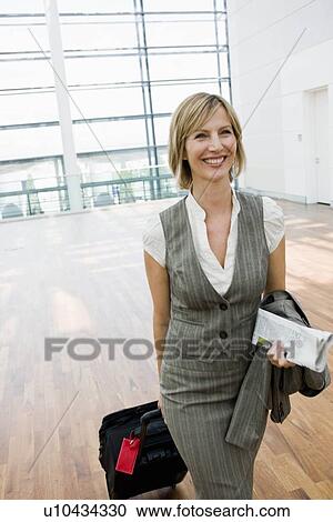 Woman dragging a suitcase View Large Photo Image Stock Image - Woman dragging a suitcase. Fotosearch