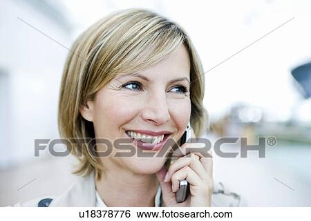 Woman smiling talking on cell phone View Large Photo Image Stock Photograph - Woman smiling talking on cell phone. Fotosearch
