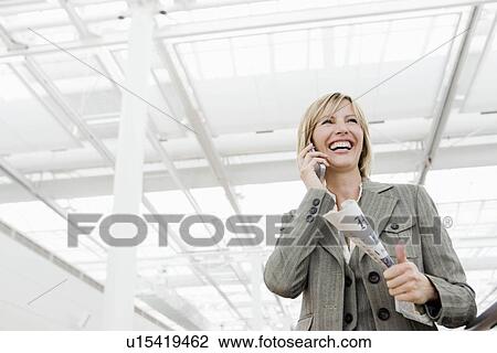 Woman smiling using cell phone View Large Photo Image Stock Image - Woman smiling using cell phone. Fotosearch