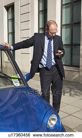Man sending message on mobile phone View Large Photo Image Stock Photograph - Man sending message on mobile phone. Fotosearch