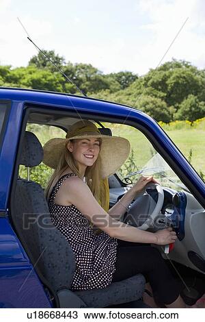 Young woman at wheel of electric car View Large Photo Image Stock Image - Young woman at wheel of electric car. Fotosearch