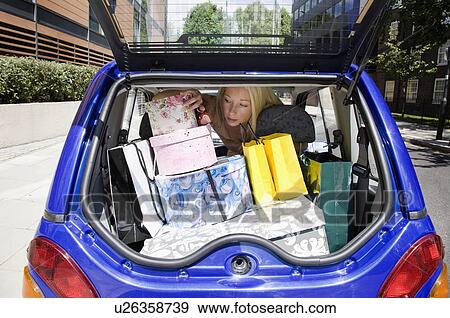 Young woman loading electric car View Large Photo Image Stock Photo - Young woman loading electric car. Fotosearch