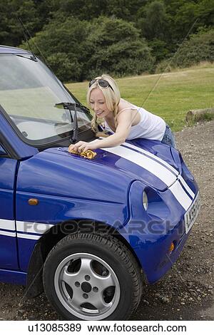 Young woman washing electric car View Large Photo Image Stock Photo - Young woman washing electric car. Fotosearch