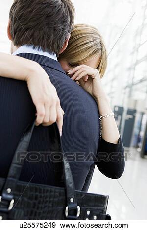Couple at airport embracing each other View Large Photo Image Stock Photo - Couple at airport embracing each other. Fotosearch