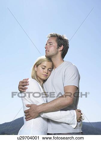 Couple embracing in sun View Large Photo Image Stock Image - Couple embracing in sun. Fotosearch