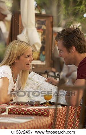 Couple laughing in french market cafe View Large Photo Image Stock Photo - Couple laughing in french market cafe. Fotosearch