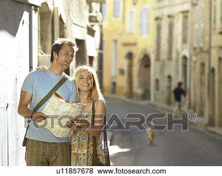 Couple studying map in street View Large Photo Image Stock Photo - Couple studying map in street. Fotosearch