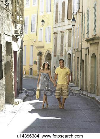 Picture - Couple walking down street in provence. Fotosearch
