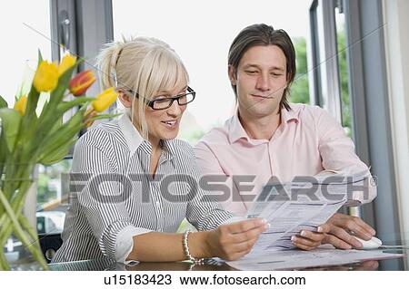 Stock Image - Couple working at home. Fotosearch