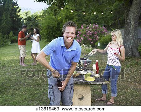 Friends celebrating at barbecue View Large Photo Image Stock Photo - Friends celebrating at barbecue. Fotosearch