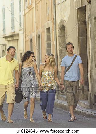 Stock Photography - Friends walking along street. Fotosearch