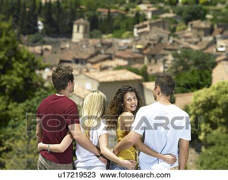 Stock Image - Girl smiling in group looking at view. Fotosearch