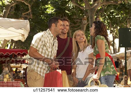 Group of friends shopping in market View Large Photo Image Stock Image - Group of friends shopping in market. Fotosearch