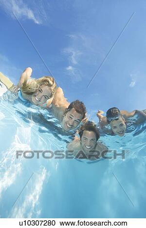 Group of friends submerged in pool View Large Photo Image Stock Image - Group of friends submerged in pool. Fotosearch