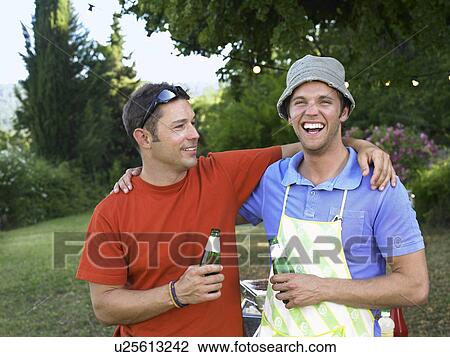 Two men at barbecue View Large Photo Image Stock Image - Two men at barbecue. Fotosearch