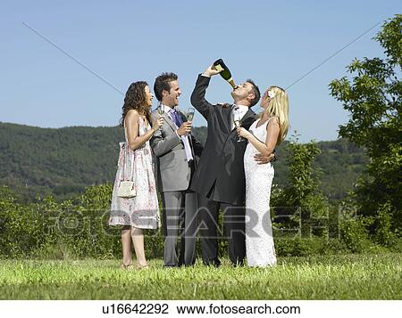 Stock Image - Wedding group drinking champagne. Fotosearch