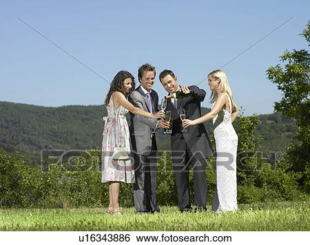 Wedding party pouring champagne View Large Photo Image Stock Photograph - Wedding party pouring champagne. Fotosearch