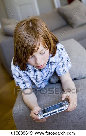 Boy playing video games View Large Photo Image Stock Photo - Boy playing video games. Fotosearch