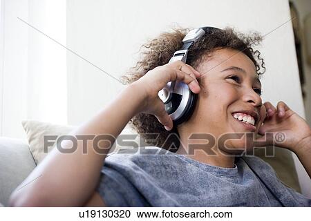 Boy with big earphones enjoying music View Large Photo Image Stock Image - Boy with big earphones enjoying music. Fotosearch
