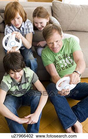 Family playing video games with wheel View Large Photo Image Stock Image - Family playing video games with wheel. Fotosearch