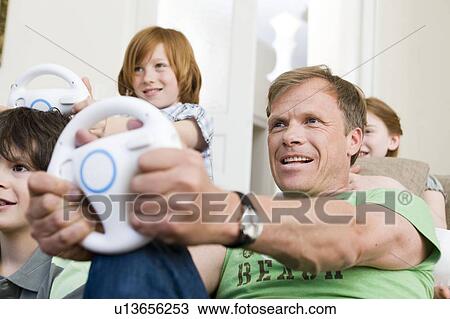 Father driving virtual with a wheel View Large Photo Image Stock Image - Father driving virtual with a wheel. Fotosearch