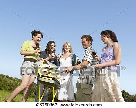 Group of young people by barbecue View Large Photo Image Stock Photo - Group of young people by barbecue. Fotosearch