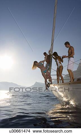 Picture - Group on sailboat. Fotosearch