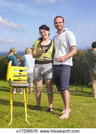 Man and woman by a barbecue View Large Photo Image Stock Image - Man and woman by a barbecue. Fotosearch