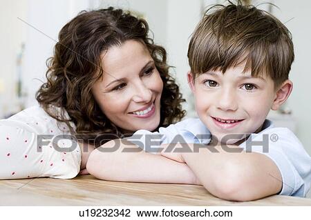 Stock Image - Woman smiling at her young boy. Fotosearch