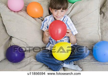 Young boy with lot of balloons View Large Photo Image Picture - Young boy with lot of balloons. Fotosearch