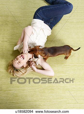 Young woman playing with dog View Large Photo Image Picture - Young woman playing with dog. Fotosearch