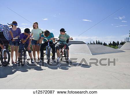 Group of teenagers at bike park View Large Photo Image Stock Photo - Group of teenagers at bike park. Fotosearch