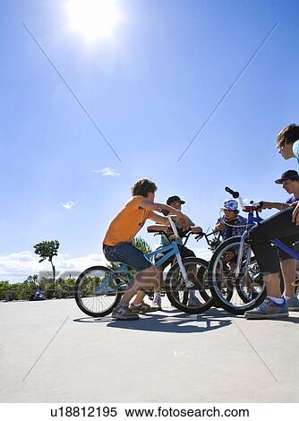 Group of teenagers on bikes View Large Photo Image Stock Photography - Group of teenagers on bikes. Fotosearch