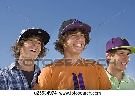 Teen boys wear baseball hat smiling View Large Photo Image Picture - Teen boys wear baseball hat smiling. Fotosearch
