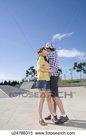 Stock Photography - Teen couple kissing. Fotosearch