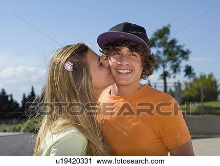 Teen girl kissing teen boy View Large Photo Image Stock Image - Teen girl kissing teen boy. Fotosearch