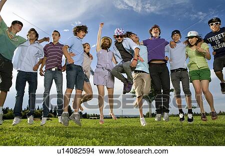 Teen group jumping in park View Large Photo Image Picture - Teen group jumping in park. Fotosearch
