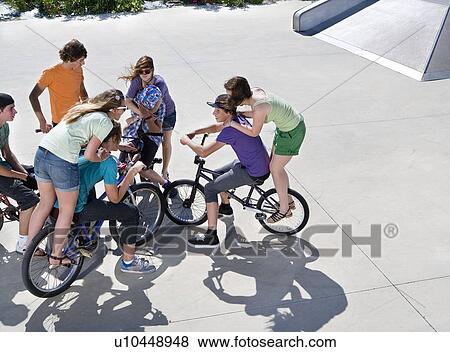 Teen group on bikes View Large Photo Image Stock Photo - Teen group on bikes. Fotosearch