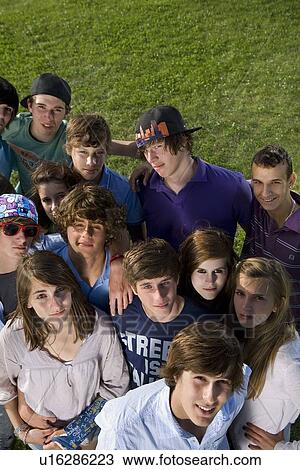 Teen group portrait standing on grass View Large Photo Image Stock Image - Teen group portrait standing on grass. Fotosearch