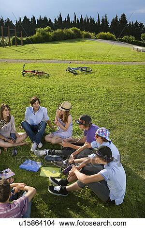 Teen group sitting on grass View Large Photo Image Picture - Teen group sitting on grass. Fotosearch