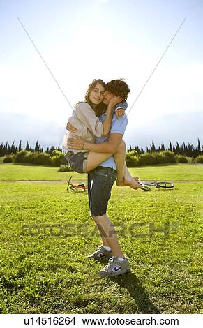 Picture - Teen lovers hug in park. Fotosearch