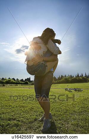 Teen lovers hug in park View Large Photo Image Stock Photo - Teen lovers hug in park. Fotosearch