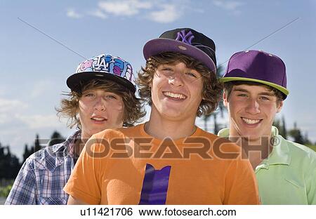 Stock Photograph - Teen triplet boys smiling portrait. Fotosearch