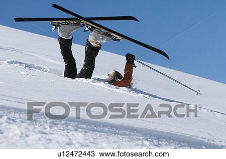 Fallen skier lying in powder snow View Large Photo Image Stock Image - Fallen skier lying in powder snow. Fotosearch