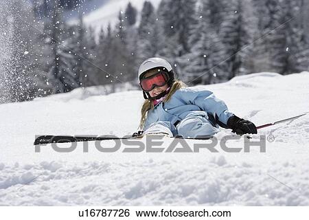 Girl with skis lying on snow View Large Photo Image Stock Photograph - Girl with skis lying on snow. Fotosearch